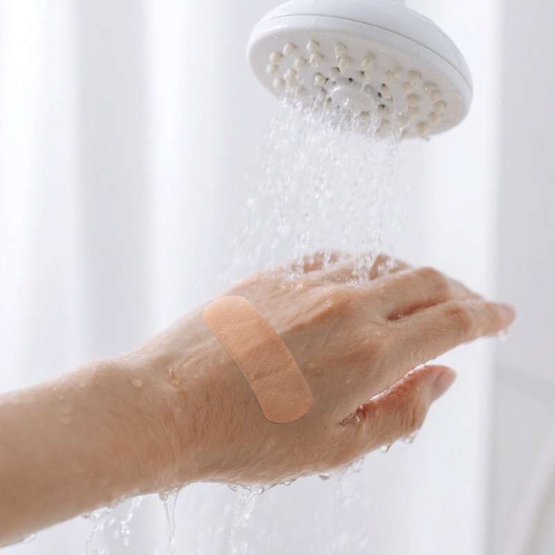 PE Woundplast on hand or finger repelling water droplets while allowing air flow