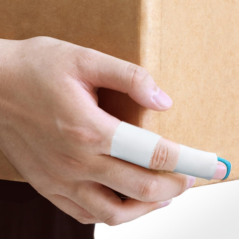 Close-up of Silk Tape being applied firmly to secure a medical dressing