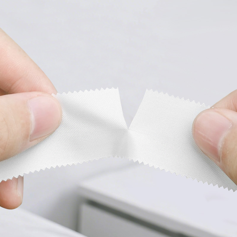 Person tearing Silk Tape by hand for convenient use