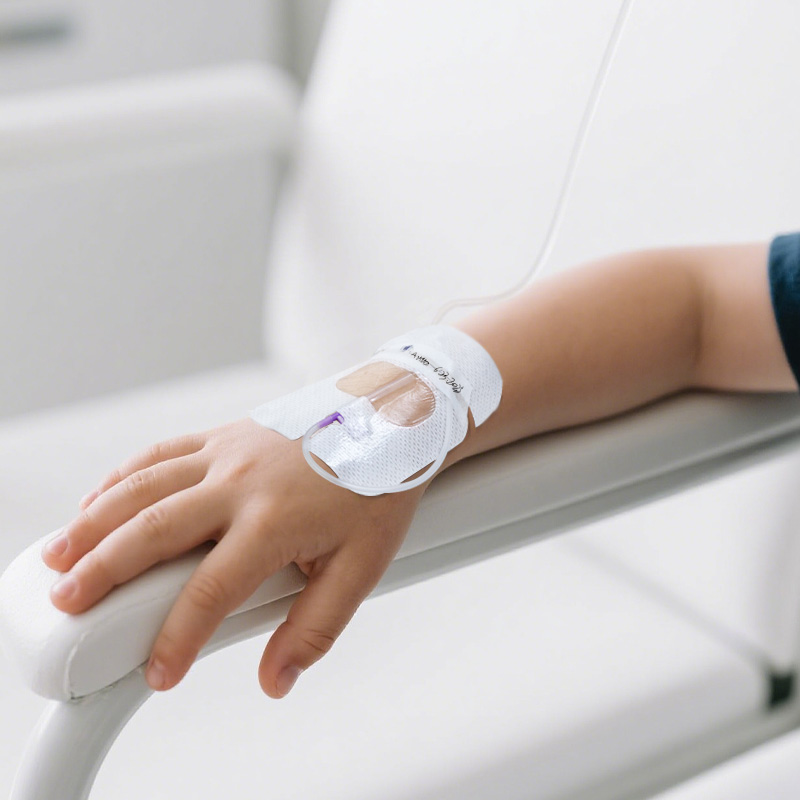 Nurse inspecting catheter site through clear I.V. dressing